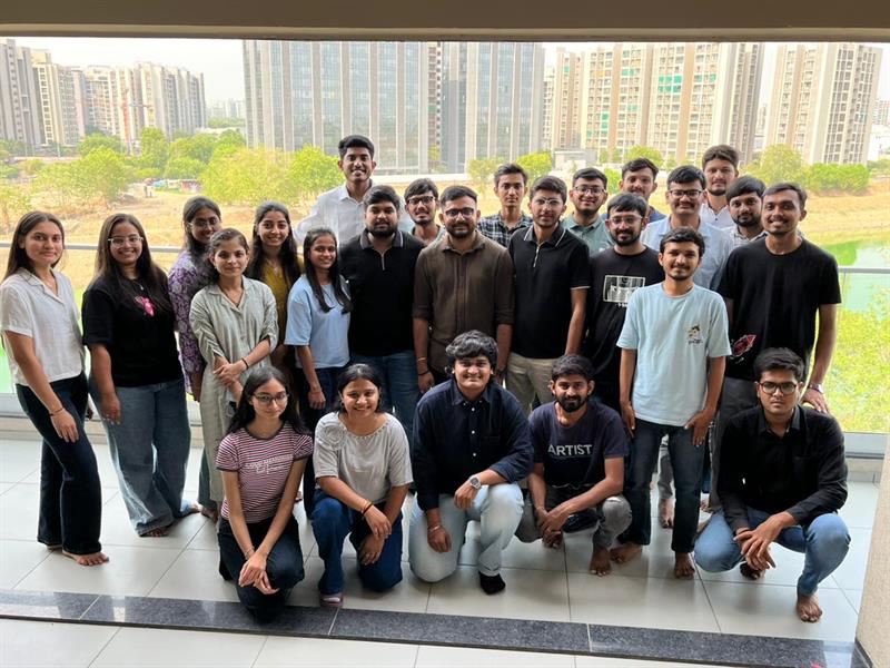 Team celebrating a milestone with cake at the office